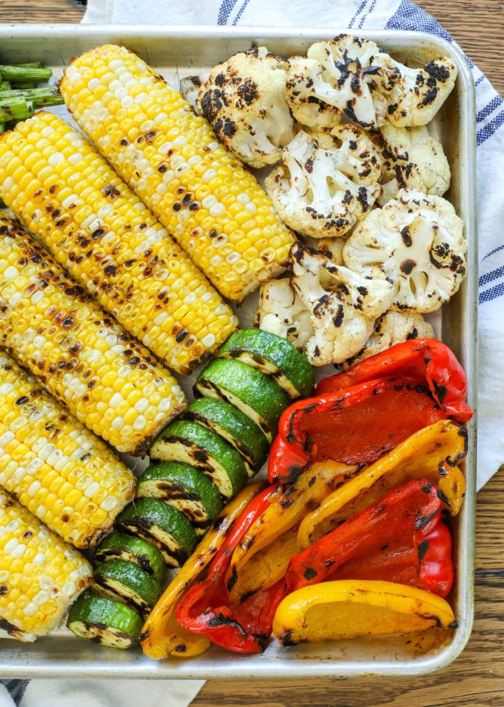 grilled corn, zucchini, and bell peppers on sheet pan