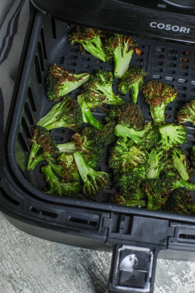 crispy browned broccoli in air fryer basket