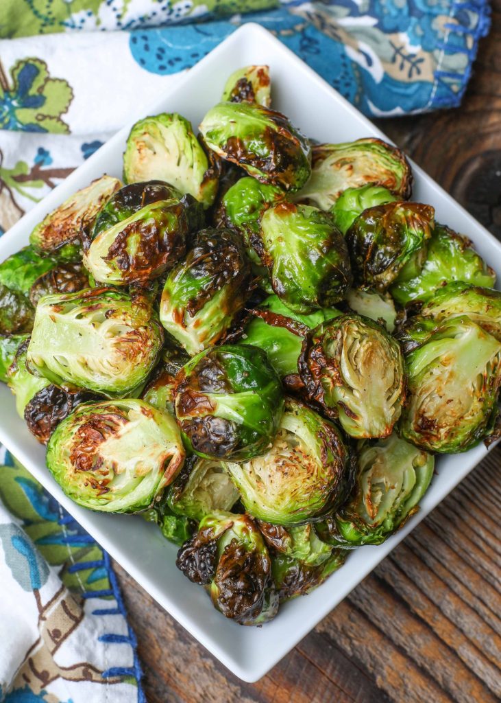Air Fryer Brussels Sprouts in square dish with blue and white napkin