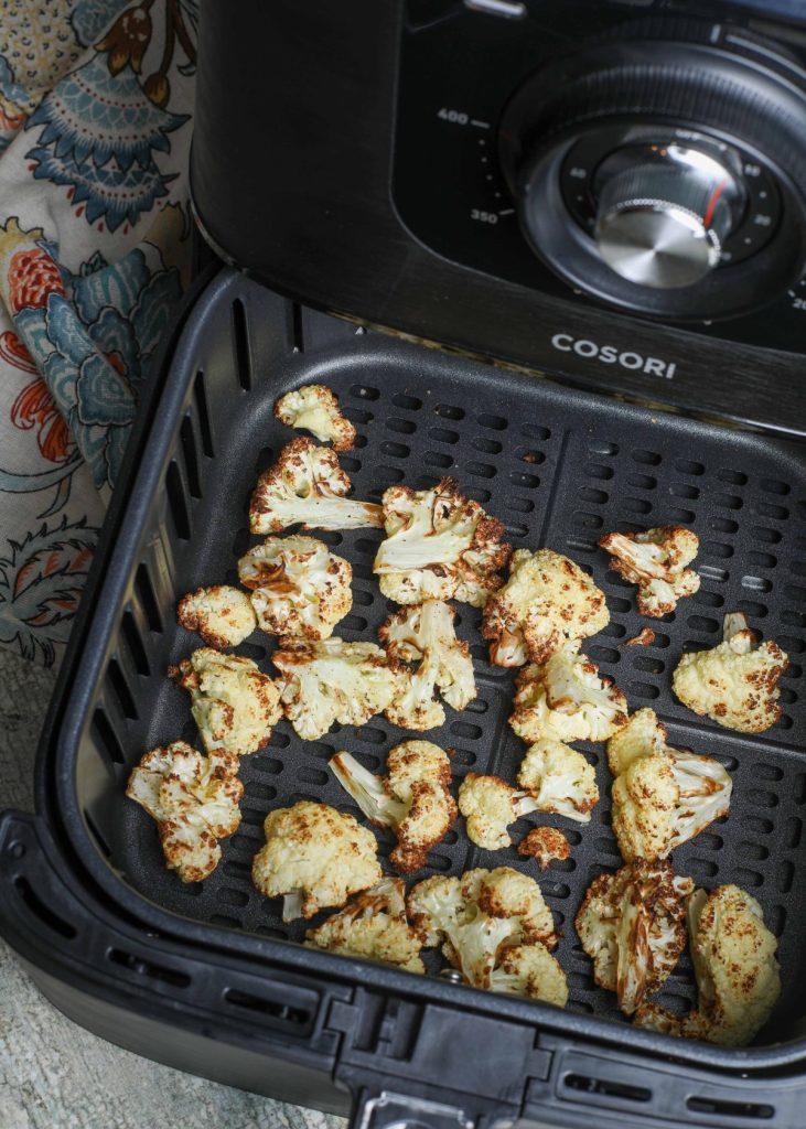 cooked cauliflower in the air fryer basket