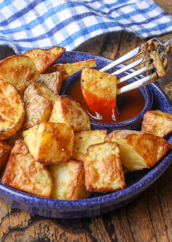 Potato chunk on fork with bbq sauce