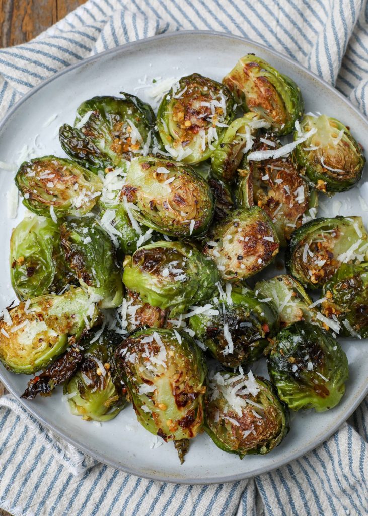 Brussels sprouts on round plate with blue napkin