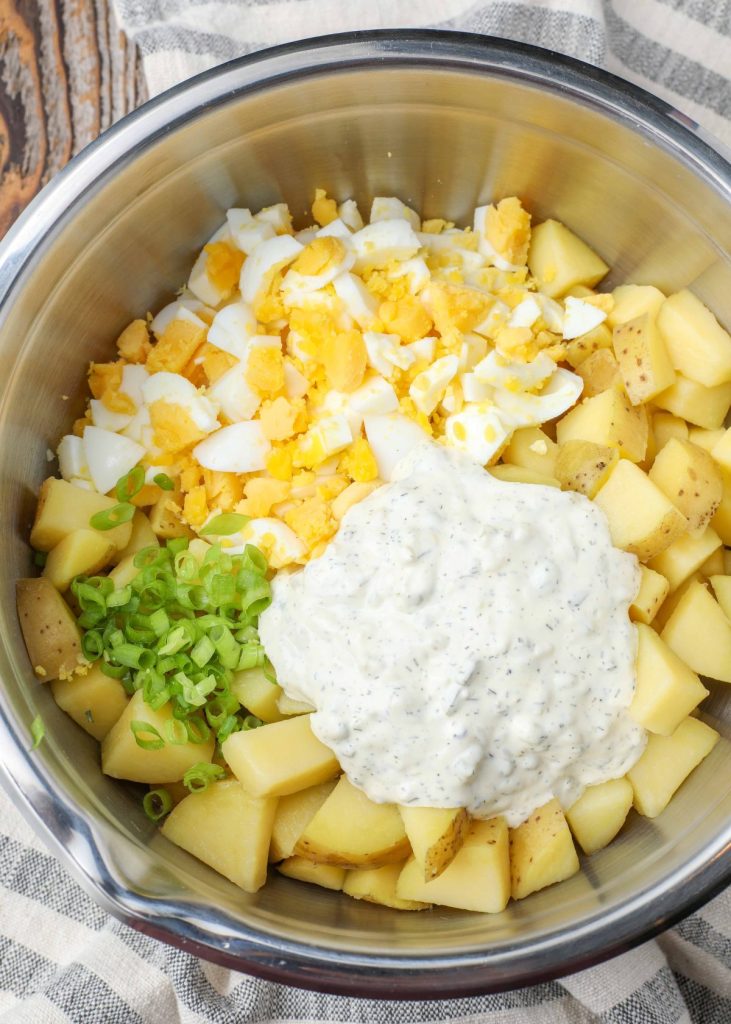potato salad ingredients in stainless bowl