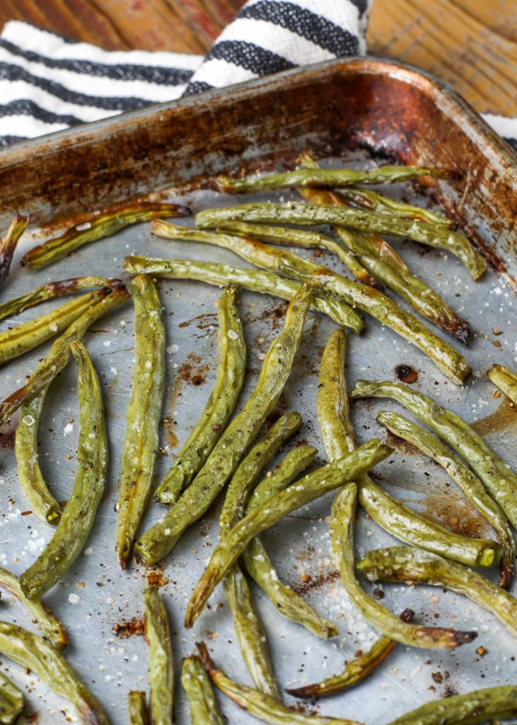 cooked green beans on baking sheet