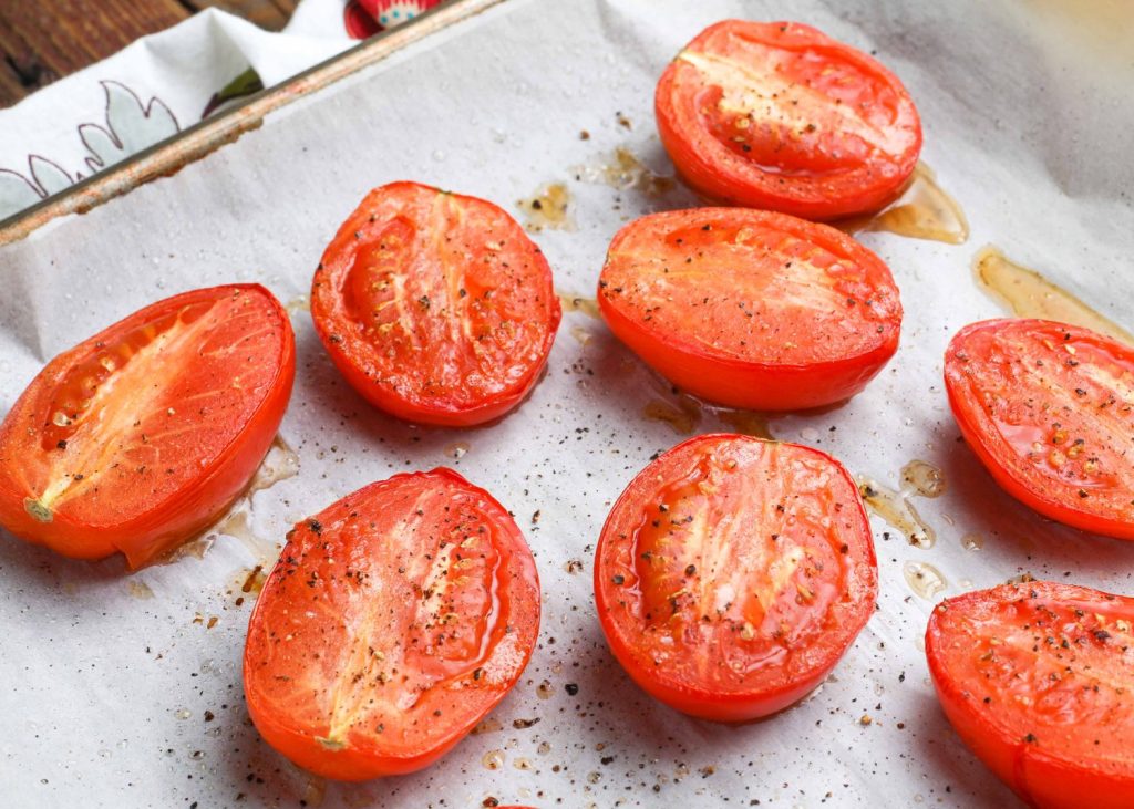 Tomatoes on baking pan with parchment