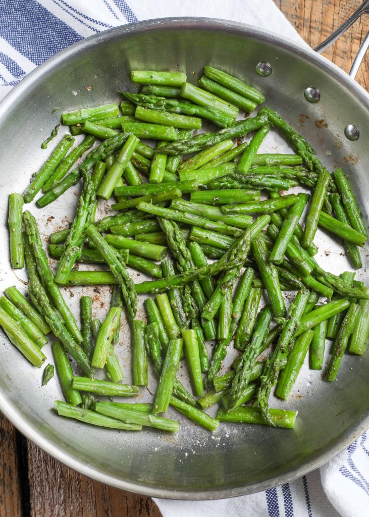 Cooked asparagus in skillet