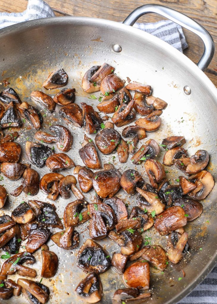Fully cooked mushrooms in stainless pan
