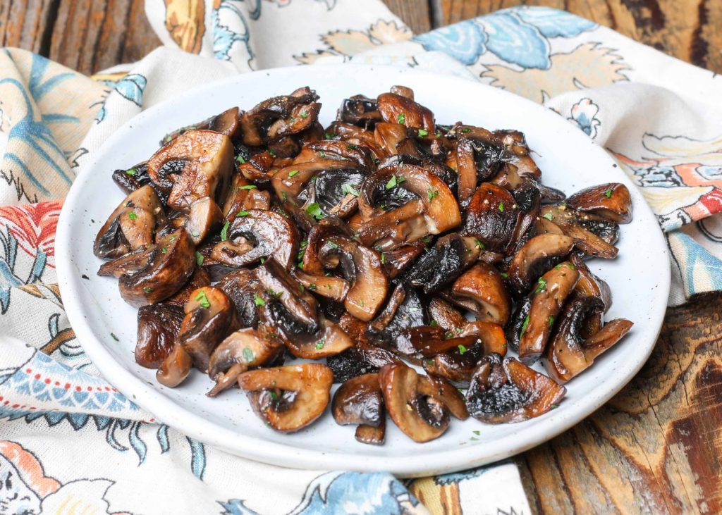 Cooked mushrooms on white plate