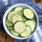 cooked zucchini rounds in white bowl