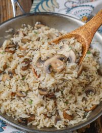 mushroom rice on wooden spoon