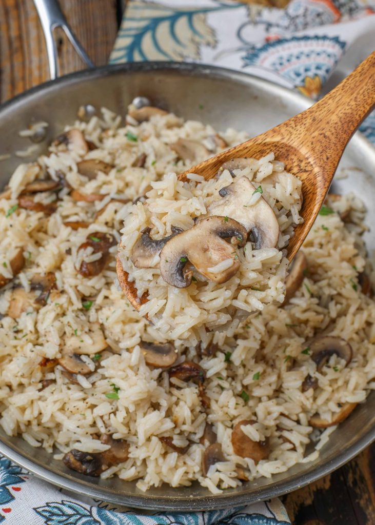 mushroom rice on wooden spoon 