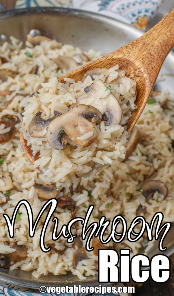 wooden spoon full of rice with mushrooms