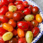 Tomatoes with herbs in bowl