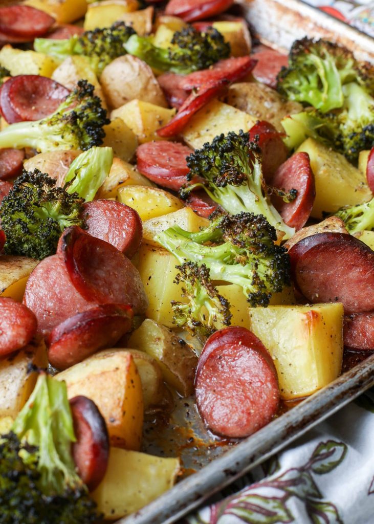 close up photo of Kielbasa, broccoli, potatoes cooked on large pan