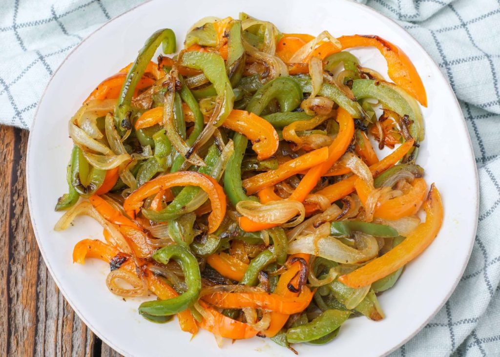 cooked peppers and onions on plate with towel