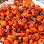 bacon and carrots on plate with black rim