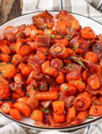 bacon and carrots on plate with black rim
