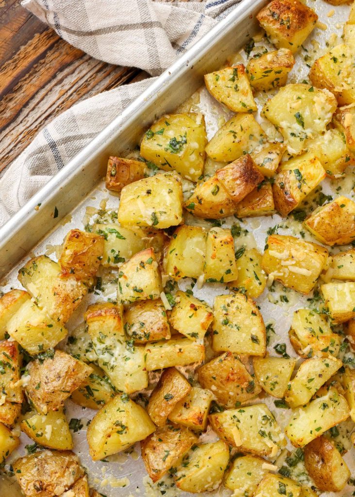 cheese and herb coated roasted potatoes on sheet pan