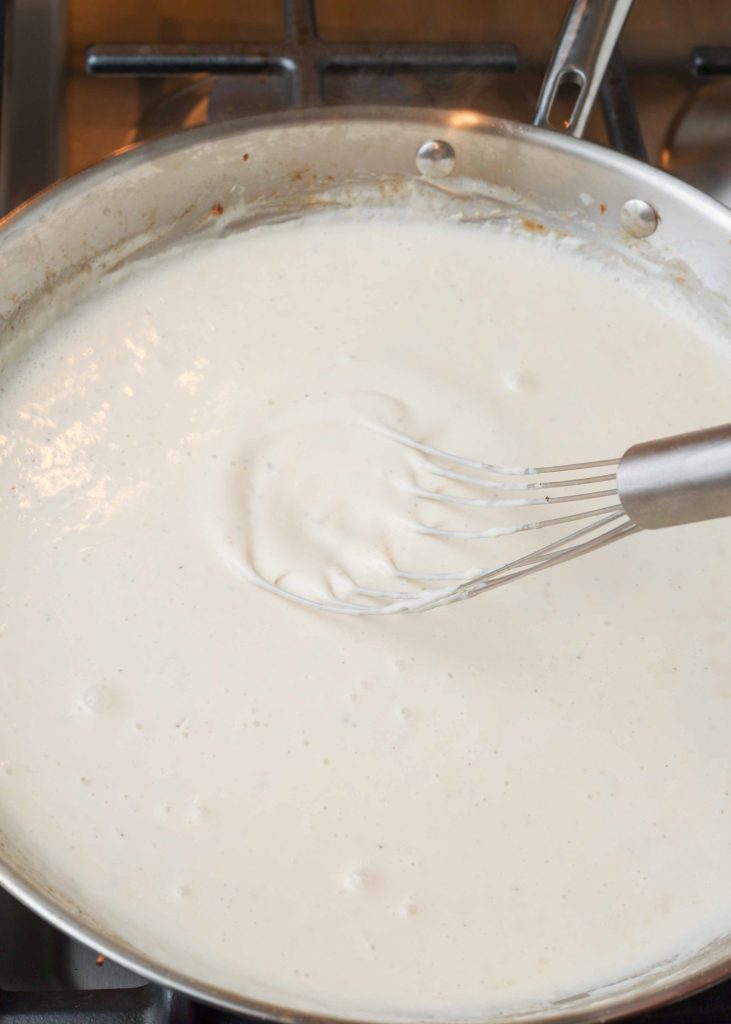 cream sauce in large skillet with whisk