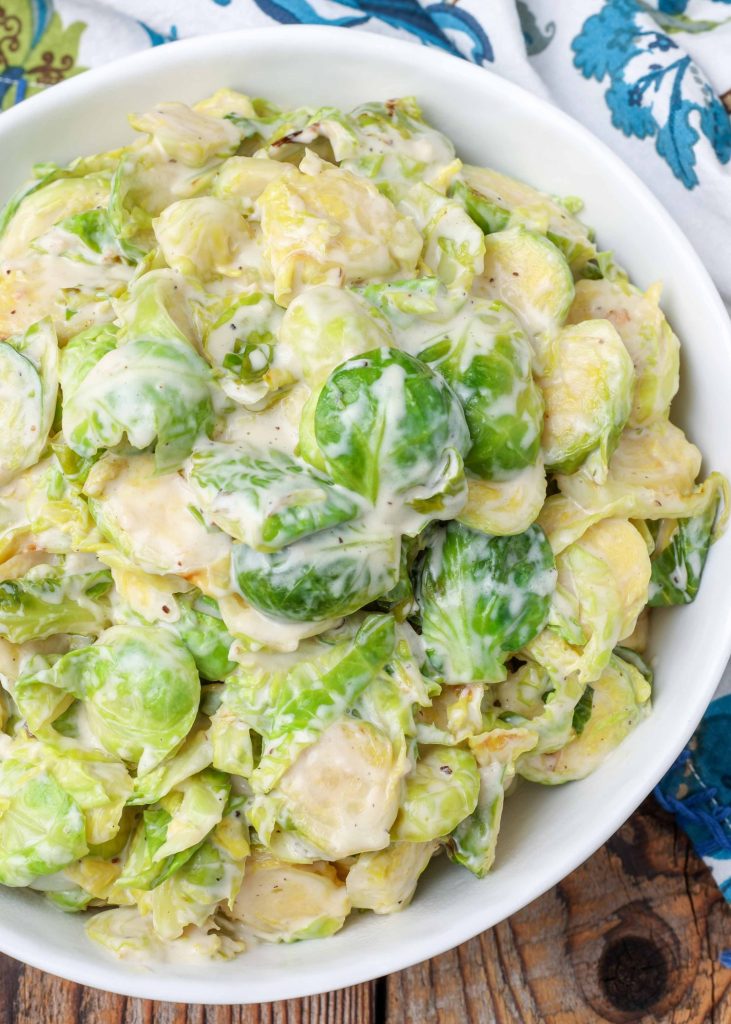 Creamy Brussels Sprouts in serving bowl with napkin