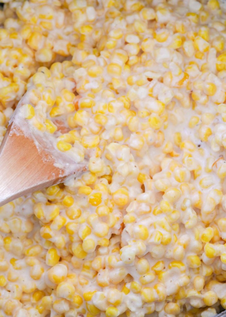creamed corn stirred with spoon