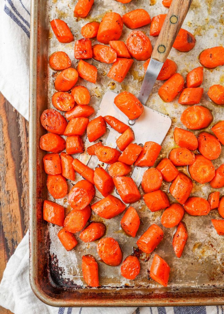 roasted carrots on baking sheet with spatula