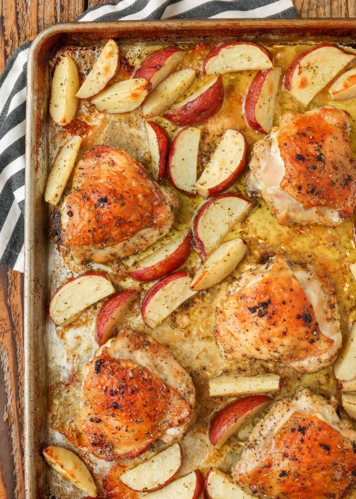 cooked chicken thighs with potatoes on sheet pan