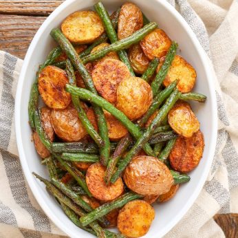 Roasted Potatoes with Green Beans in white serving dish