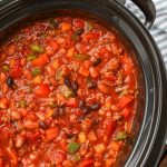 crockpot full of chili with blue towel