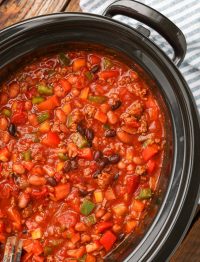 crockpot full of chili with blue towel