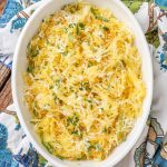 Buttered Parmesan Spaghetti Squash in oval dish with blue napkin