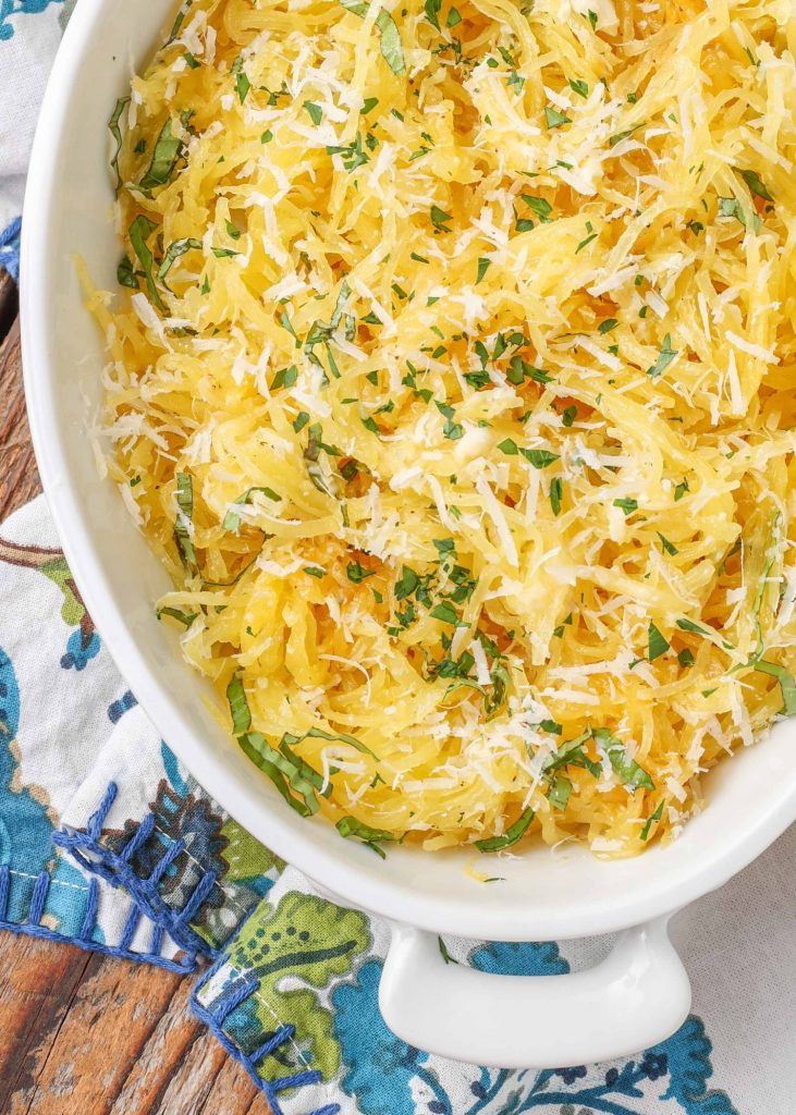 spaghetti squash with parsley in white dish with napkin