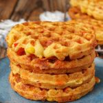 waffles made with corn and bell peppers stacked on blue plate