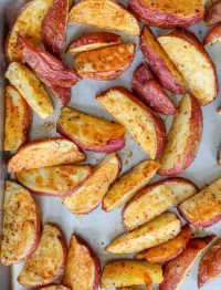 red potatoes with chili seasoning on baking sheet