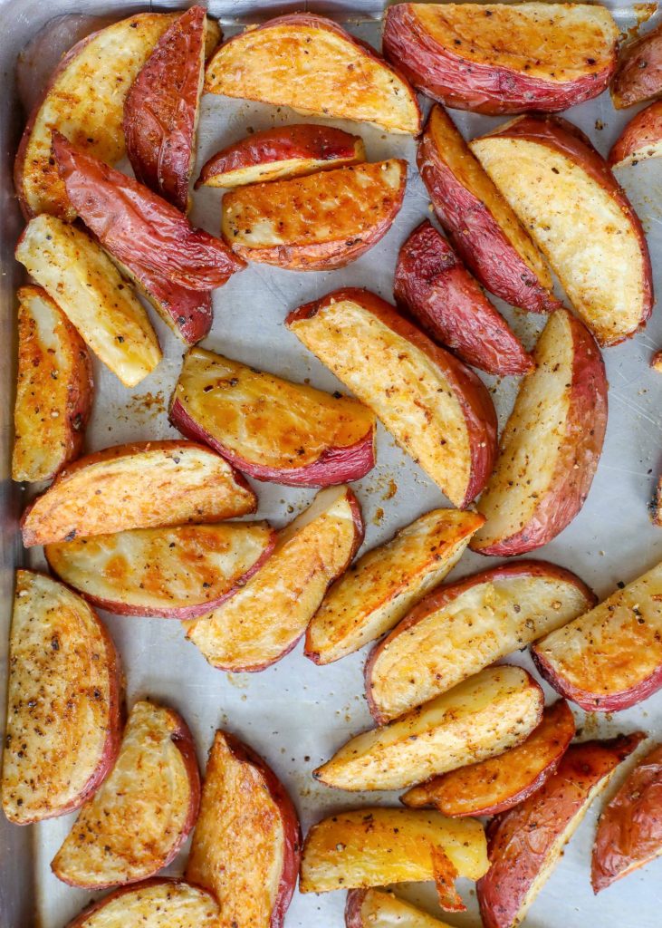red potatoes with chili seasoning on baking sheet
