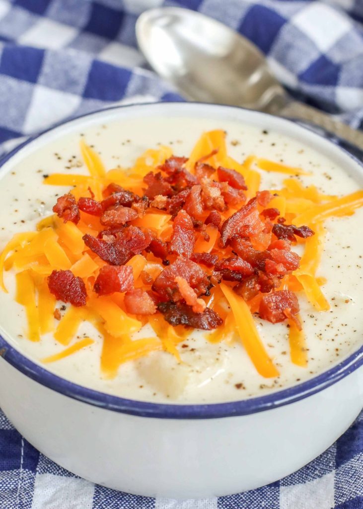 potato soup with bacon and cheese in white bowl