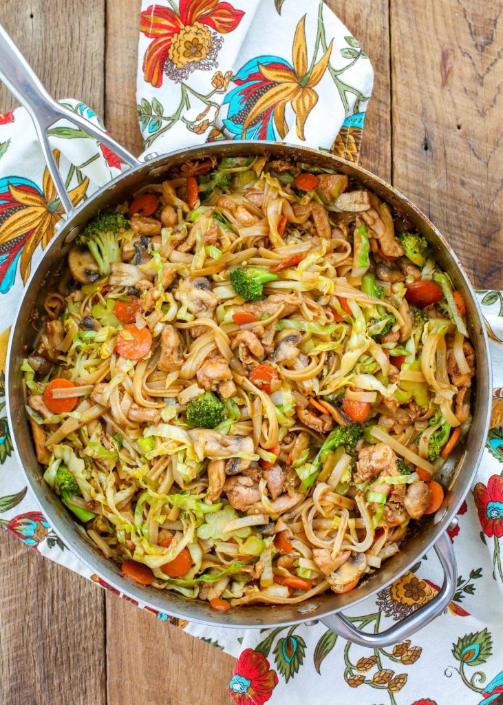 cabbage, chicken, and vegetable stir fry with noodles in large pan