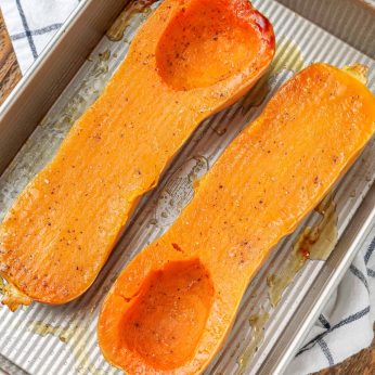roasted butternut squash with oil salt and pepper in pan