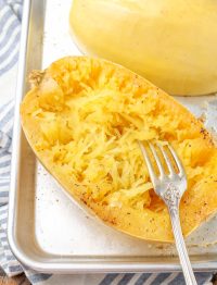roasted spaghetti squash with fork on tray