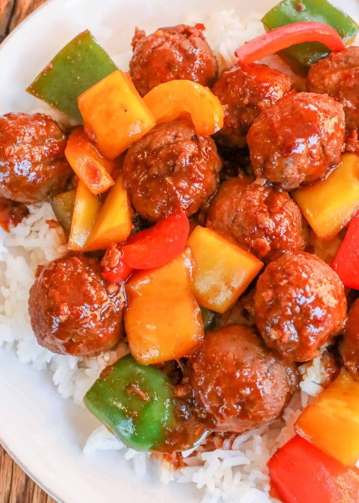 meatballs with rice and bell peppers on white plate
