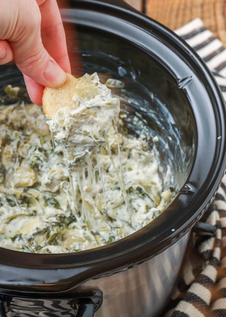 Slow Cooker Artichoke Dip with Spinach on cracker