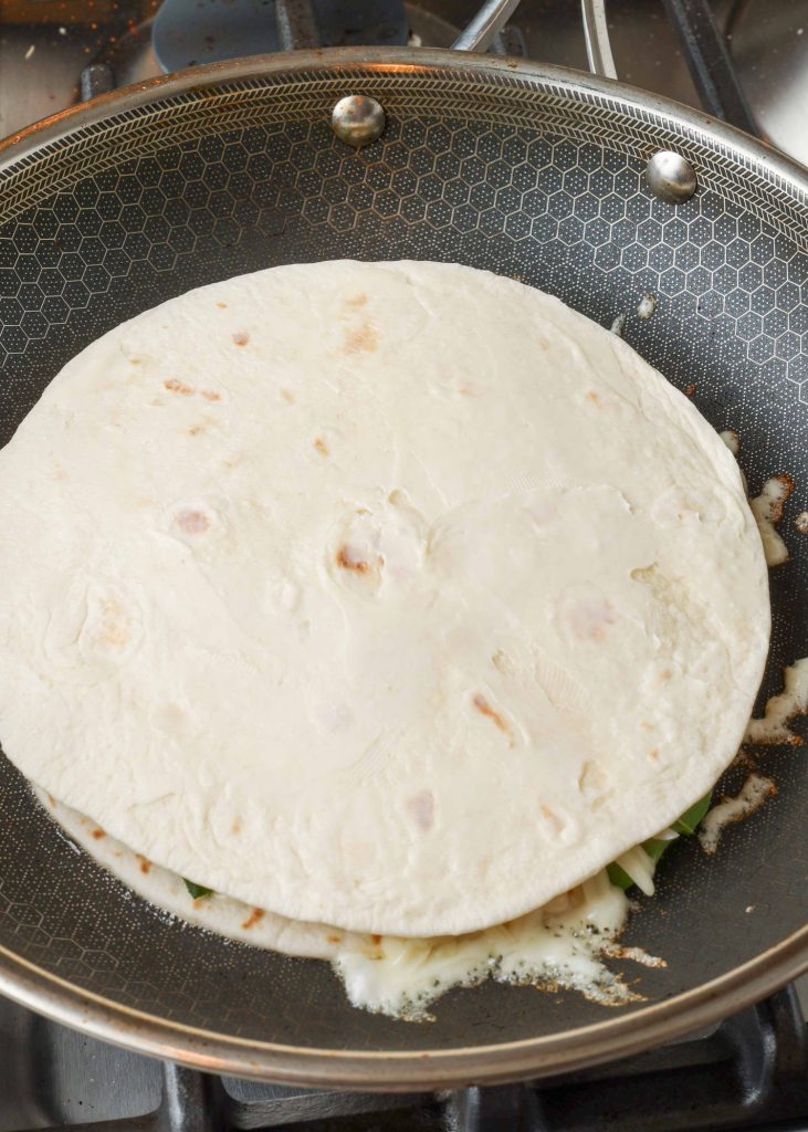 Spinach Quesadilla uncooked in skillet