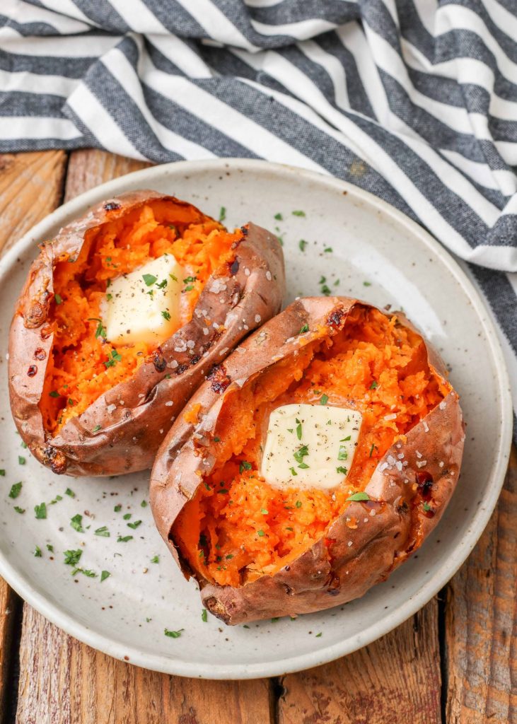 Baked Sweet Potato Air Fryer two potatoes on plate with blue and white linen
