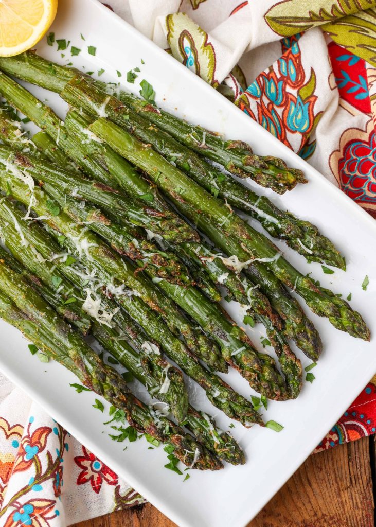 Air Fryer Frozen Asparagus on white plate with parmesan