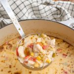 Creamy Chicken Corn Soup in Dutch oven with ladle