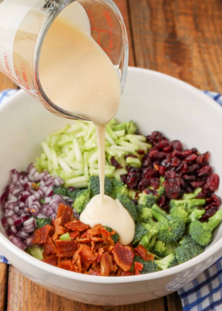 Cranberry Broccoli Bacon Salad with dressing being poured