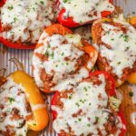 cheesy stuffed peppers in pan with plaid towel
