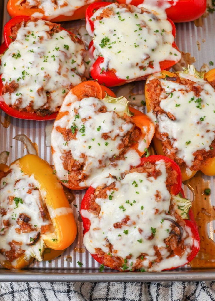 cheesy stuffed peppers in pan with plaid towel