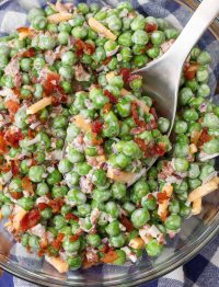 peas, cheddar cheese, and bacon salad in bowl