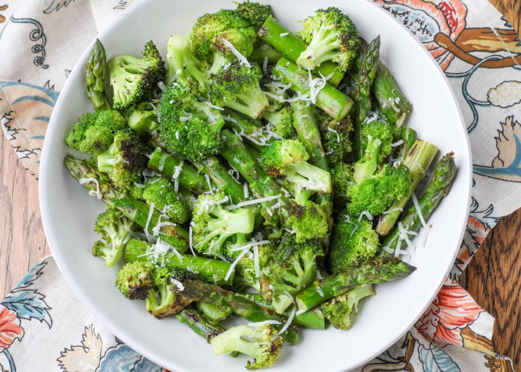 Asparagus and broccoli in white bowl